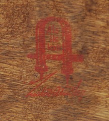 Close-up of red decal Gustav Stickley signature, circa 1905-1912.